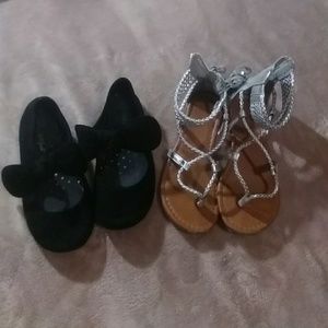 Silver sandals and black flats with a bow.